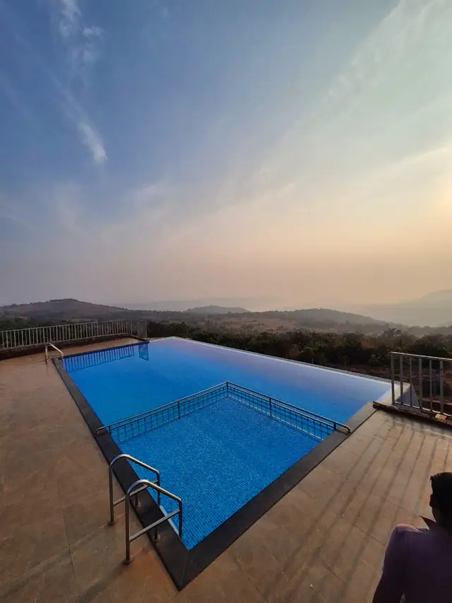 Pool contractor — Hilltop infinity-edge pool at sunset
