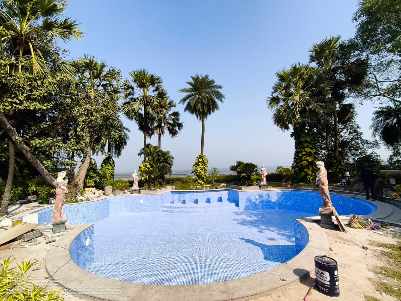 Pool contractor — Grecian-style resort leisure pool with classical statues and sea view by Dreamz Pools