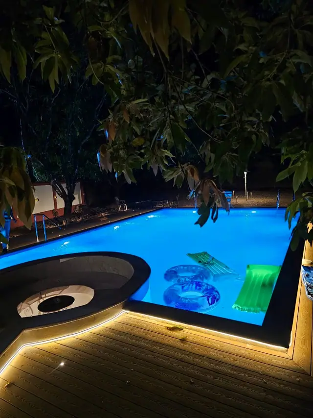 Pool contractor — Backyard pool with LED night lighting