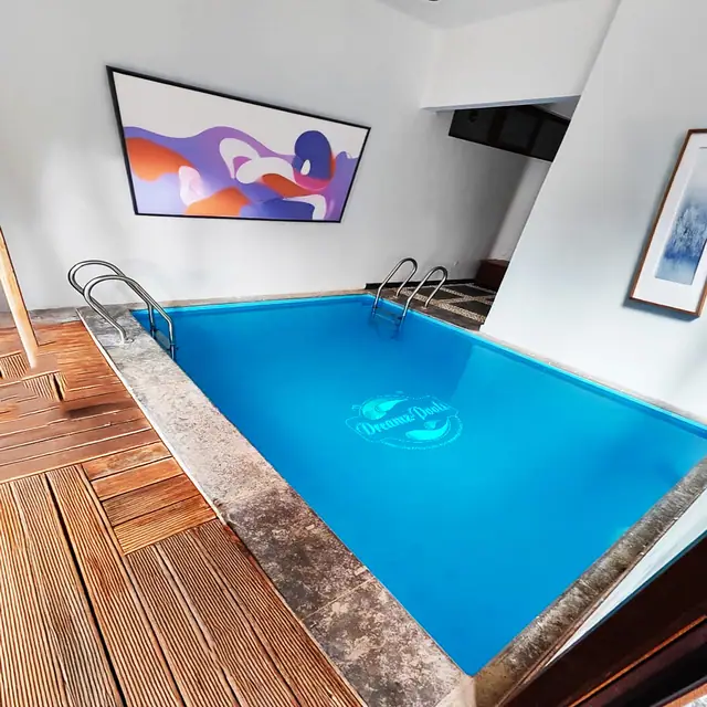 Pool contractor — Indoor pool with wooden deck and modern interior