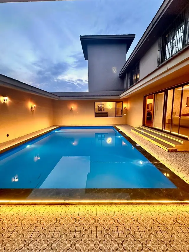 Pool contractor — Completed FRP swimming pool with clear blue water and surrounding deck