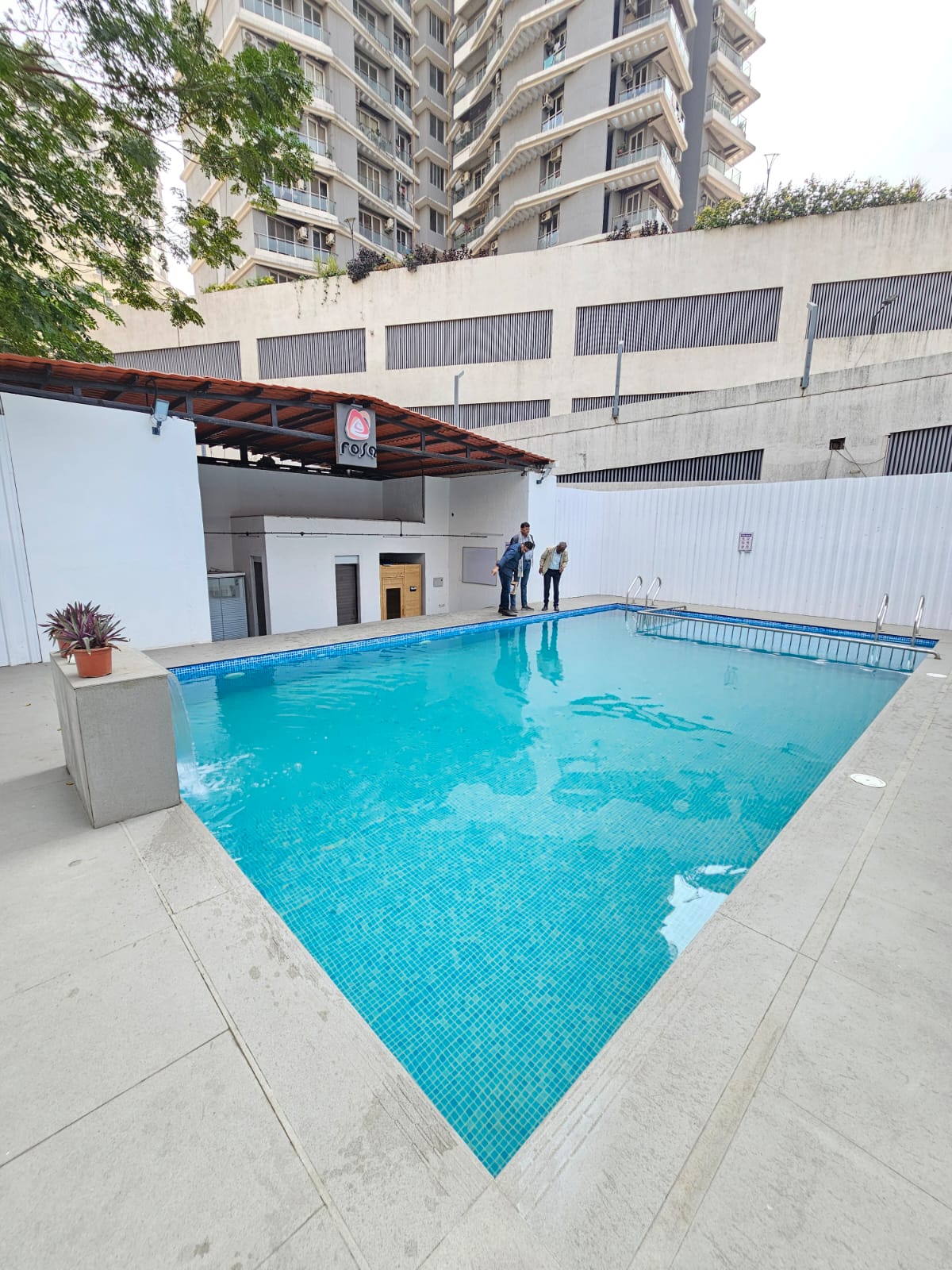 Pool contractor — Rosa clubhouse pool with cascade water feature by Dreamz Pools