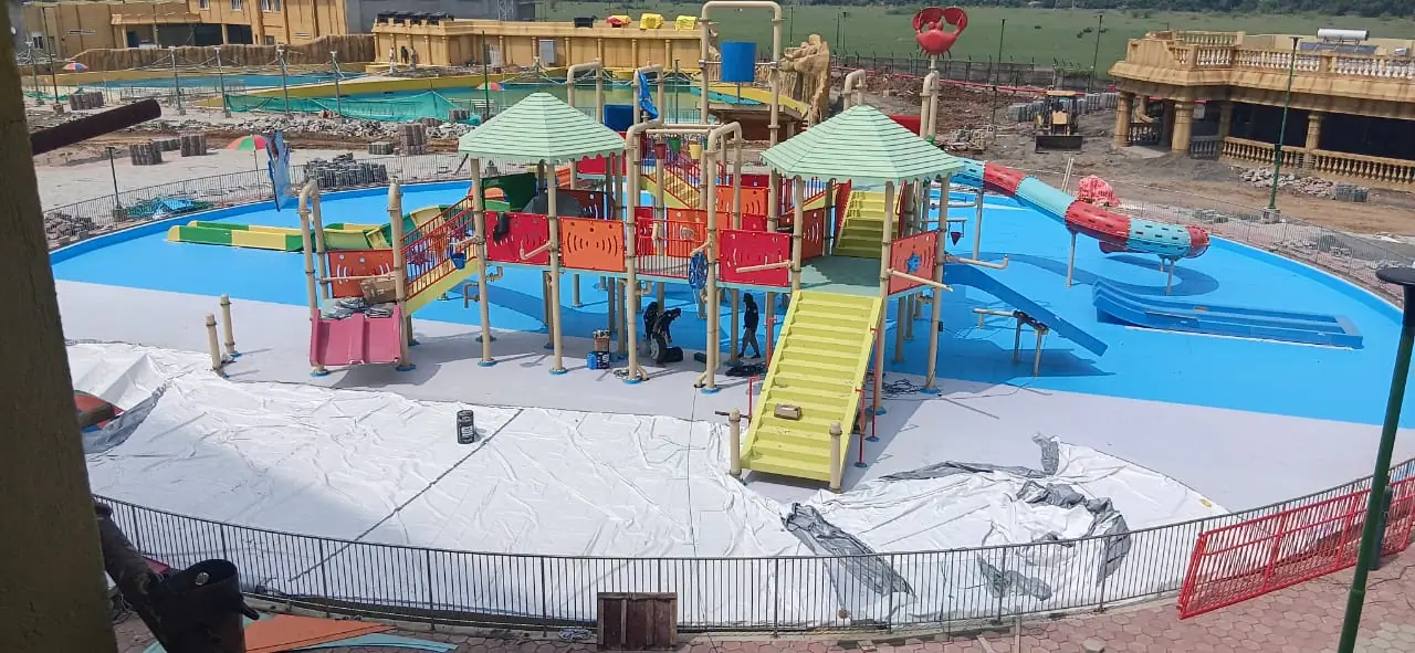 Pool contractor — Children's interactive water-play zone with FRP slides and shade canopies built by Dreamz Pools